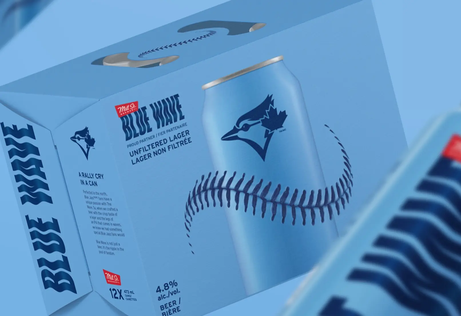 A light blue box with a blue jay logo containing cans of "Blue Wave" unfiltered lager.